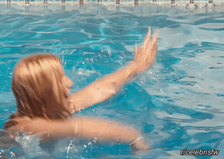 Suzanne Somers in a blue bikini jumping into a swimming pool and removing her top to show her breasts