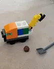 Lego poop complete with a shovel and a sewage truck.