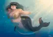 Nephyla's digital art of a busty, chubby mermaid with short blue hair swimming underwater