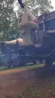 Ear candy satisfying video of a white industrial machine on a truck discharging liquid onto dirt in a wooded area