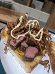 Steak sandwich with crispy shoe string onions, kewpie mayo and English mustard