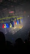 Kanye West walking on stage during the BLOHSH confetti performance with dynamic lighting.
