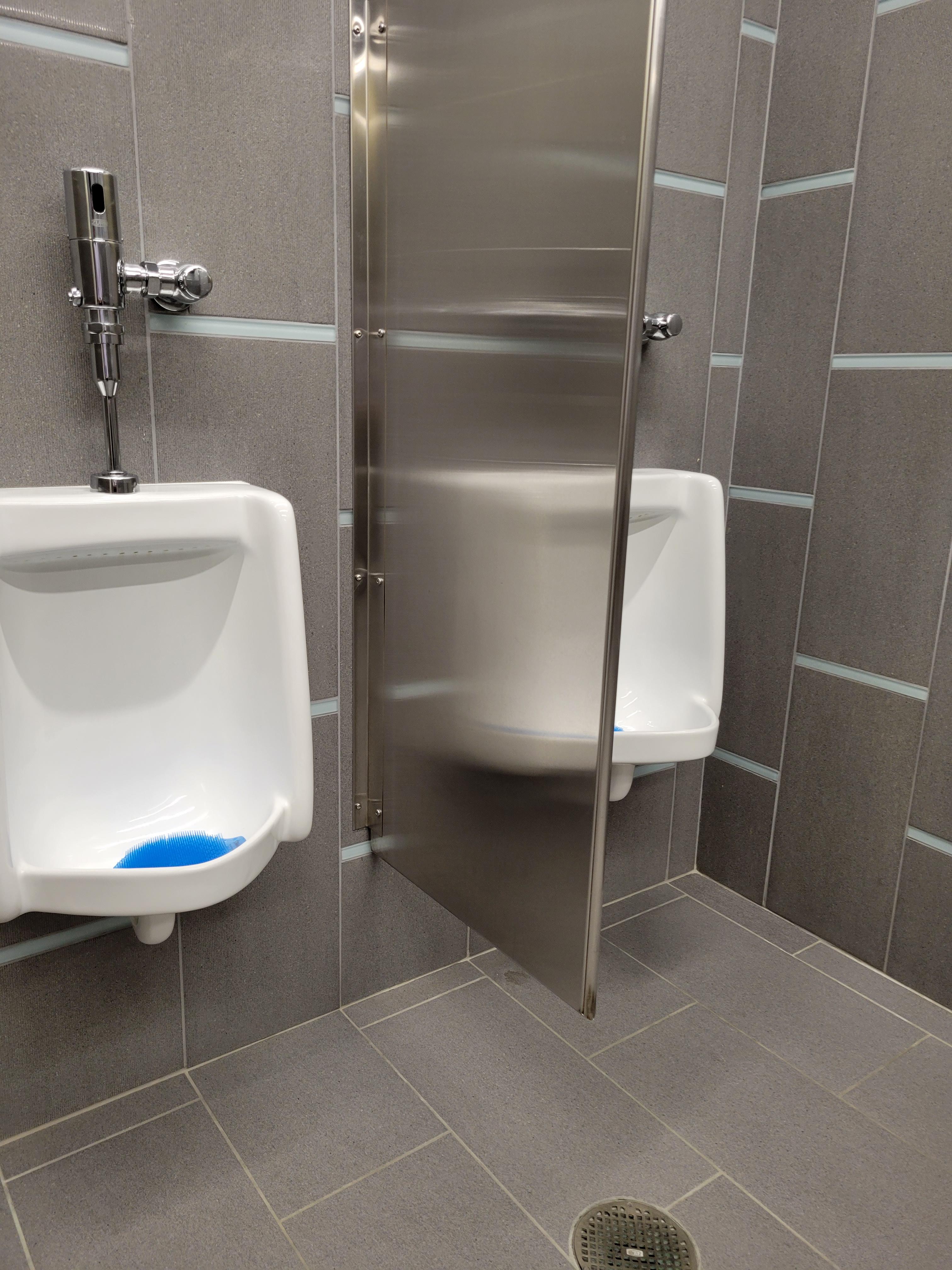 The urinal reflection makes it look like the dividers are transparent ...