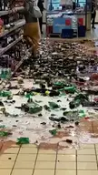 Woman destroying bottles in grocery store