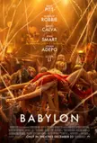 Margot Robbie in a red satin dress being lifted by a crowd in a golden-lit party scene from the movie Babylon