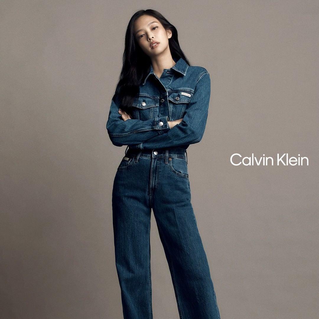 Jennie for Calvin Klein wearing a denim dress, white tank top, and denim jeans in a studio