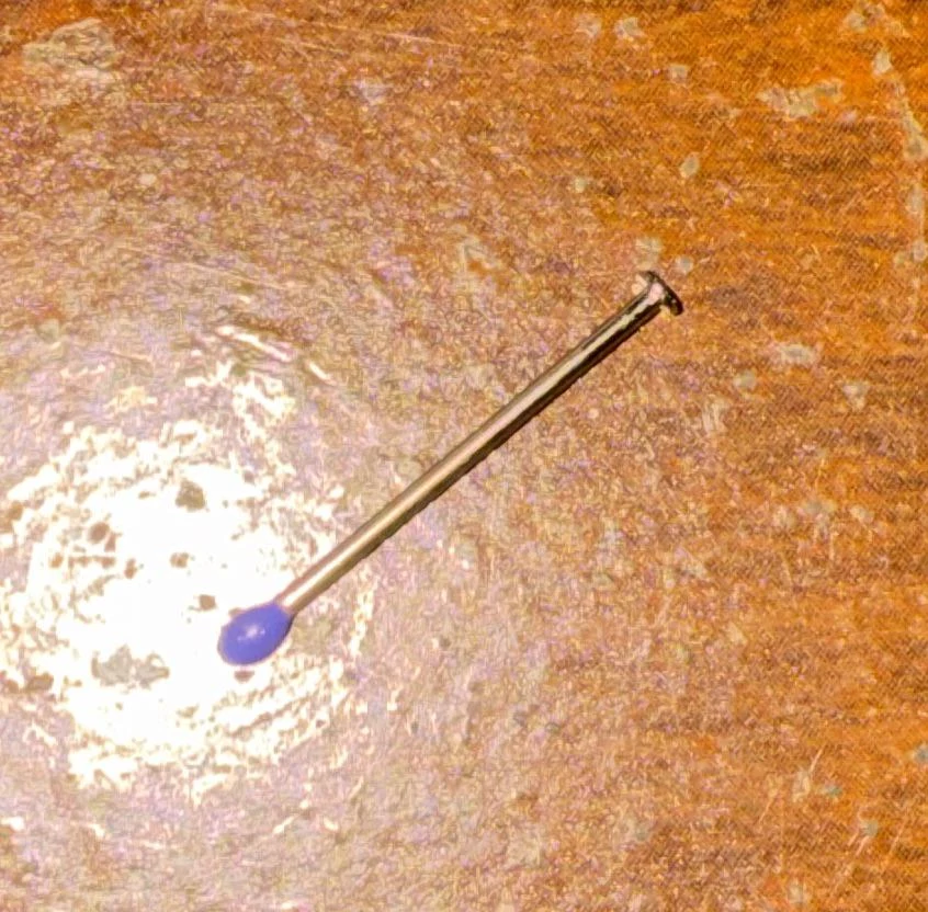 What is this, a small needle thing with a plastic colored end. i find ...