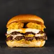 Snapped a sexy pic of a smashburger topped with deep fried pickles.