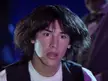 Marty from Guitar Hero with voluminous brown hair looking shocked and opening his mouth in a funny reaction gif