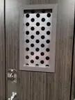 The vent holes on a Planet Fitness locker door.