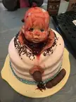 Cursed food birthday cake designed as a gory birth scene with a baby figure