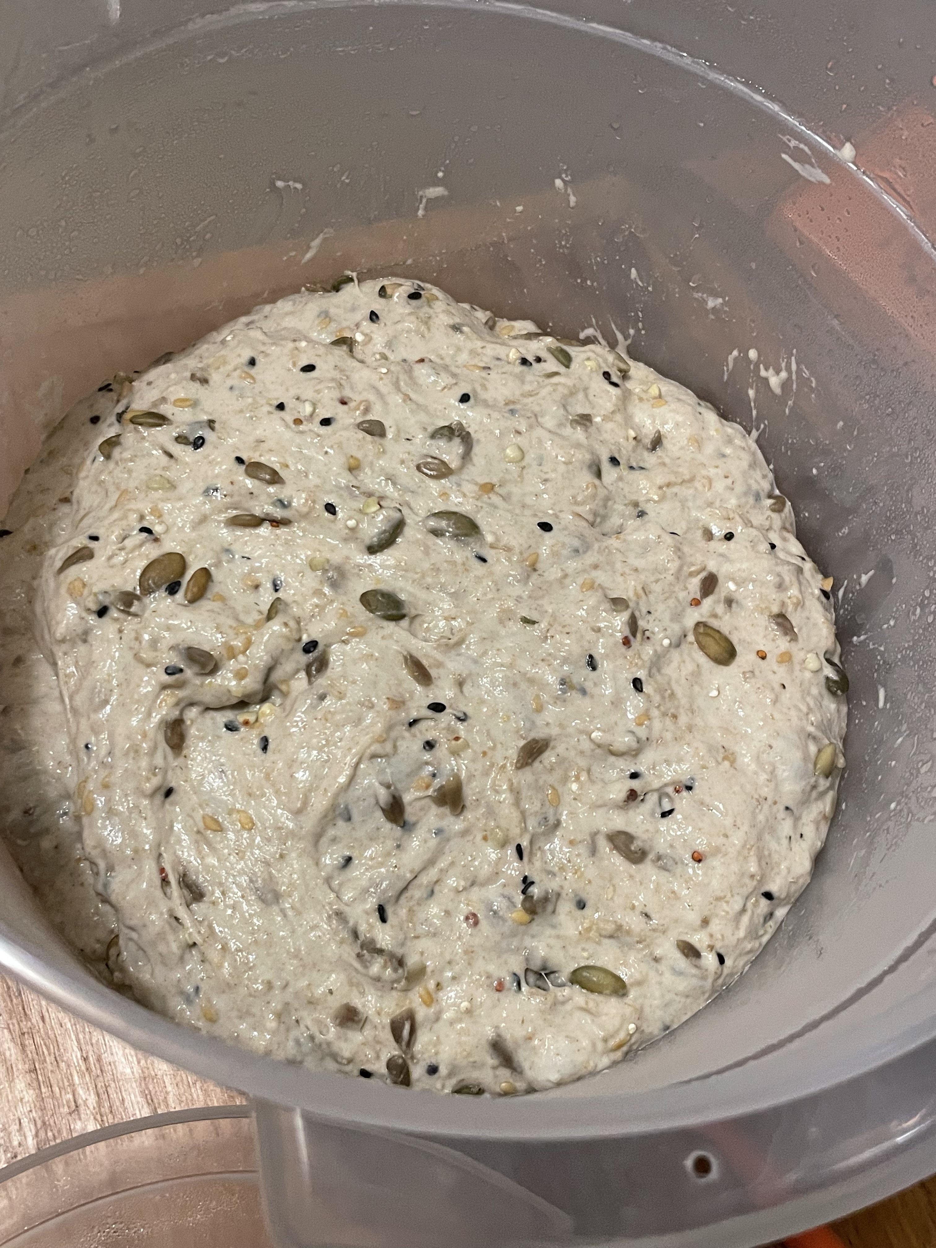 Multigrain sourdough bread from raw seeded dough to stacked baked loaves in a kitchen