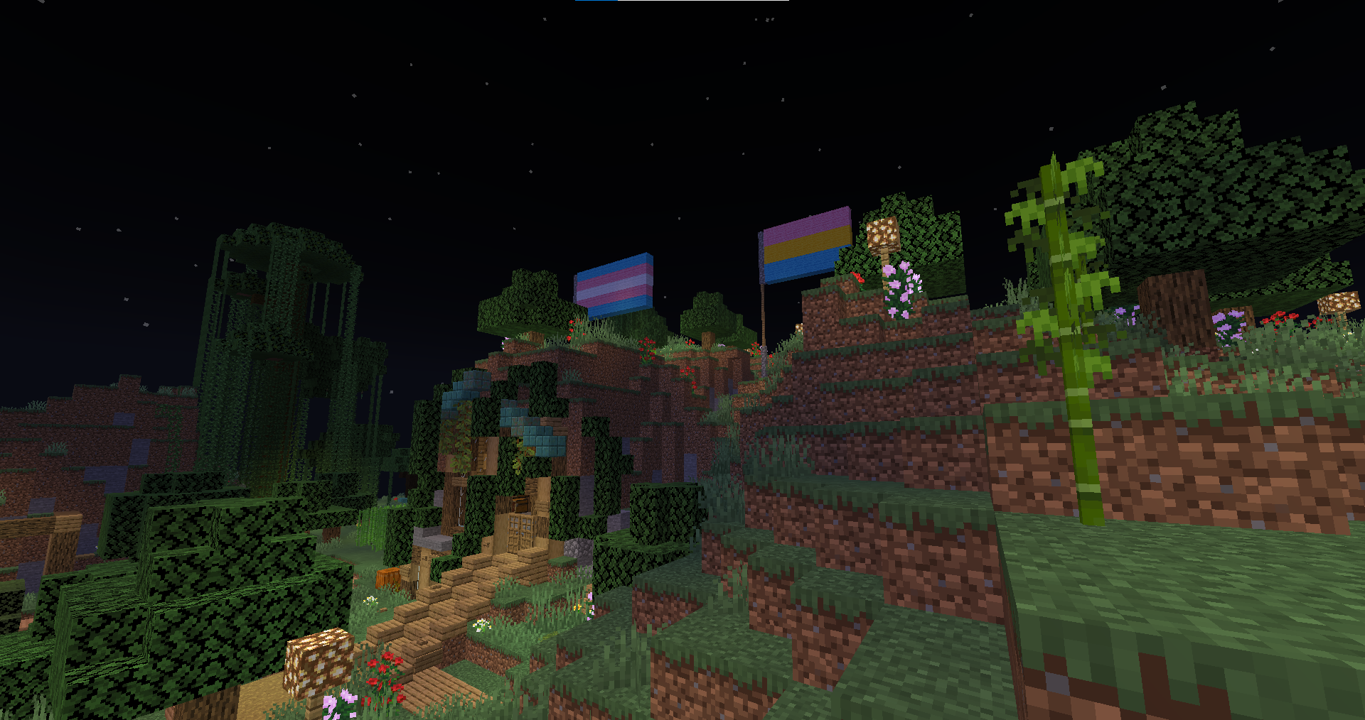 Minecraft survival builds featuring a base with flags, paths, and foliage in a beautiful landscape.