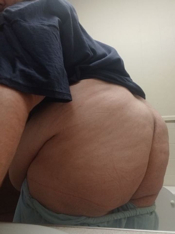 Thick white man in blue underwear posing for a pelfie showing his buttocks and lower back.