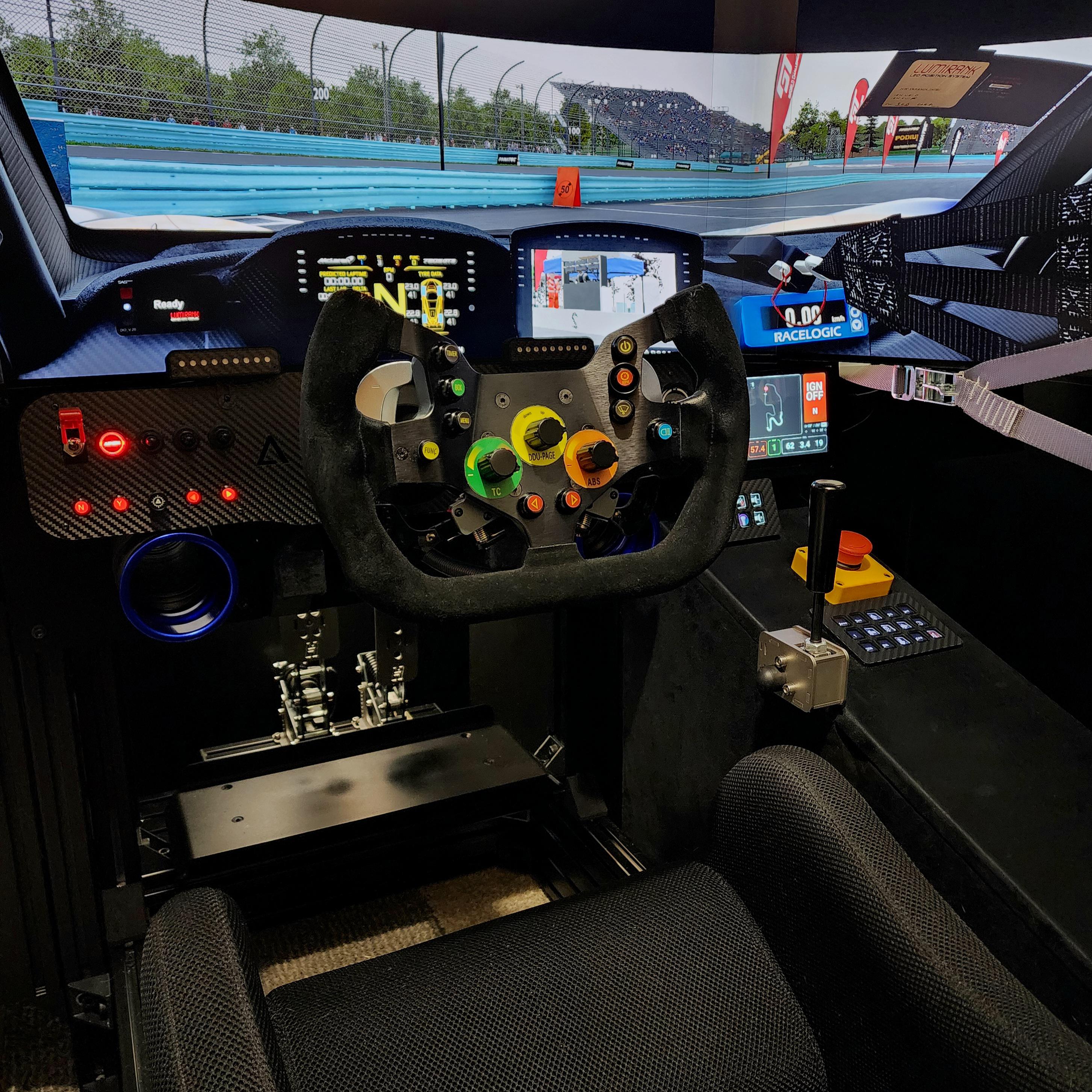 Sim racing cockpit with a professional steering wheel, digital displays, and control buttons