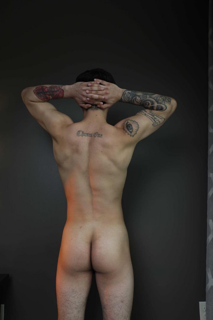 Muscular tattooed twunk in a maroon thong and nude posing with a curvy woman