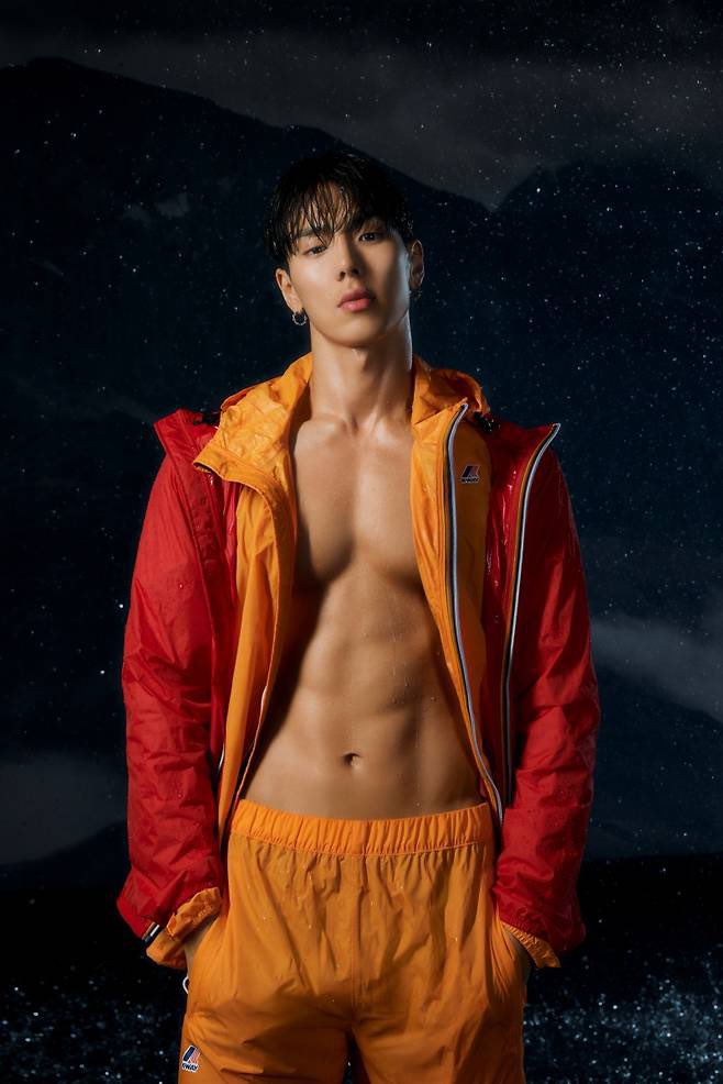 MONSTA X Shownu in red and yellow K-WAY athletic wear and streetwear against a starry background