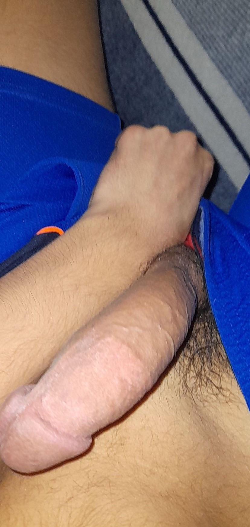 Muscular twunk college student in a bedroom posing shirtless and masturbating with an uncut penis.