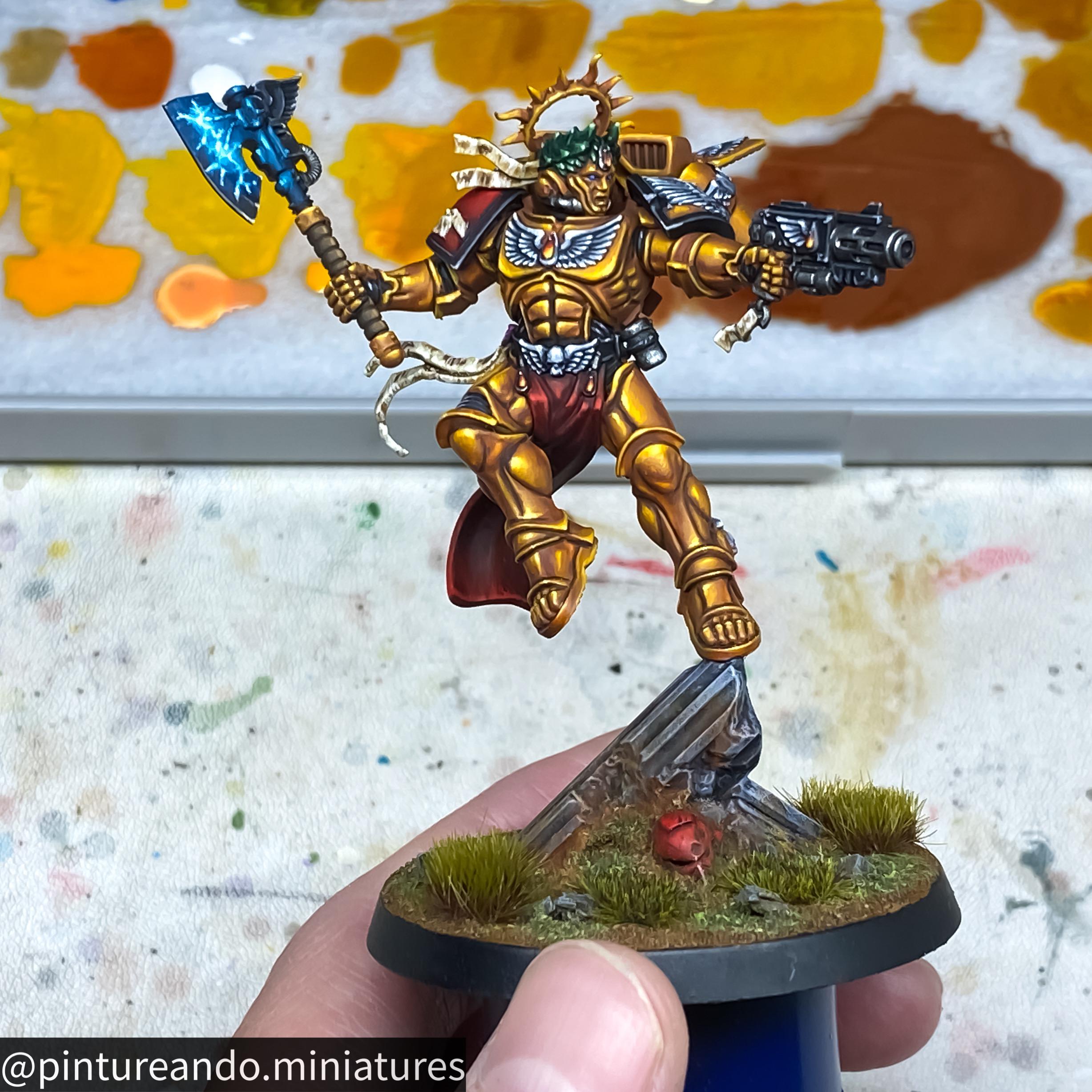 Primaris Dante miniature figure of a golden armored warrior with a blue glowing axe held by a hand