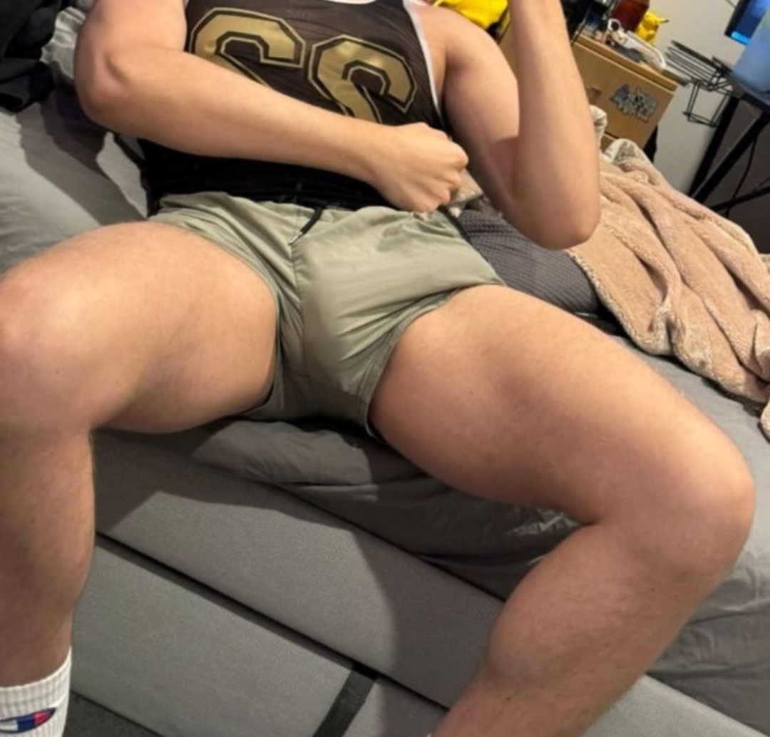 Muscular German daddy in a white tank top, basketball jersey, and black tank top posing for mirror selfies