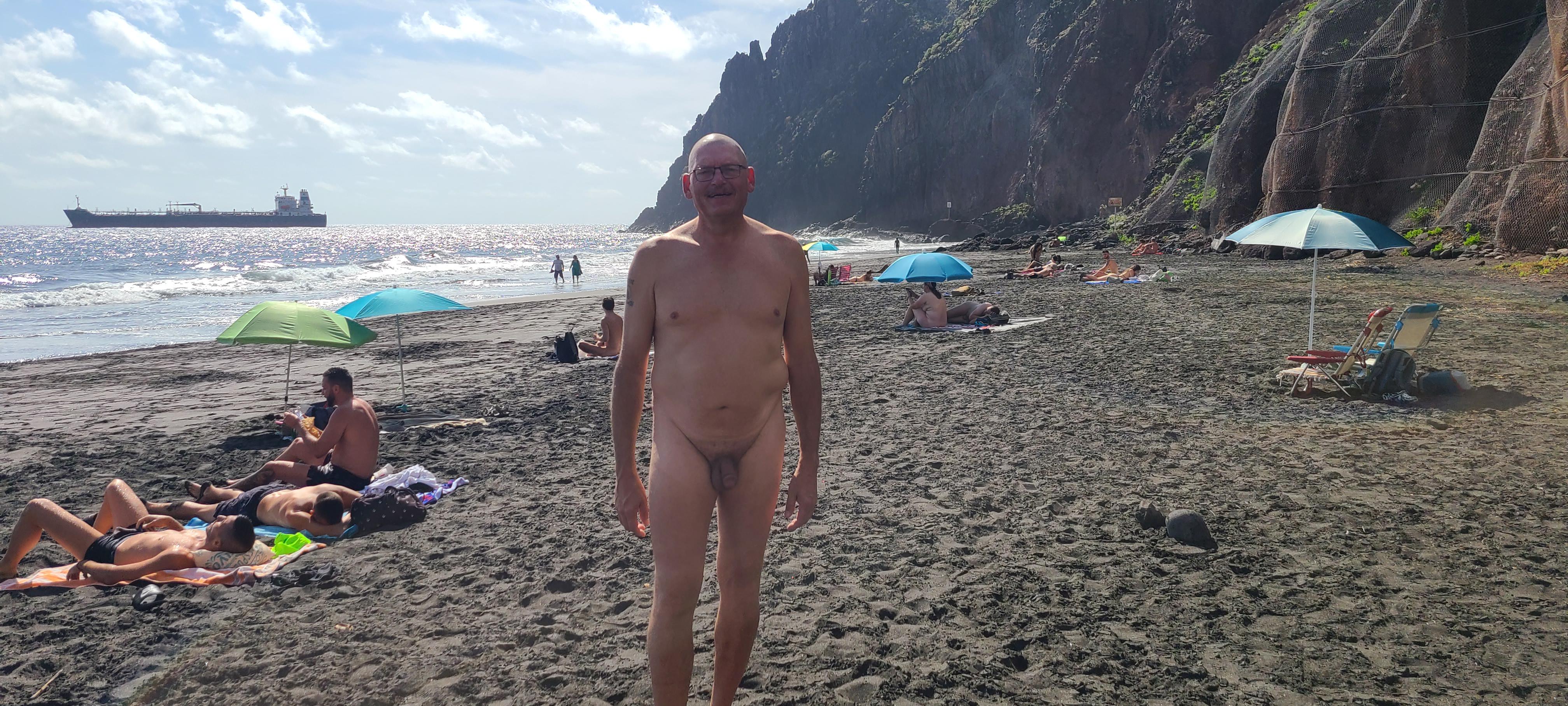 Athletic mature white man posing nude on a beach and boat, practicing naturism and FKK.