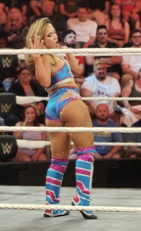 Lola Vice in a blue and pink leotard and sports bra in a WWE wrestling ring