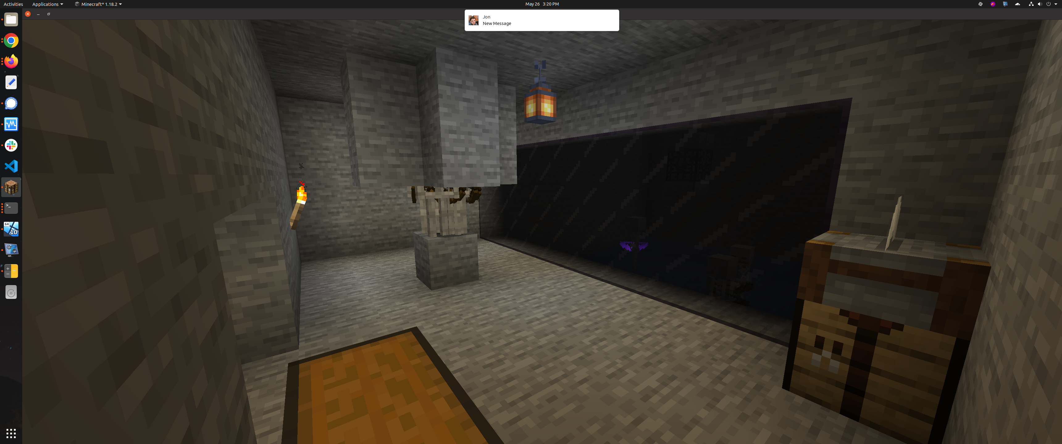 A large skull structure built into a grassy hill as an entrance to a Minecraft skeleton spawner farm
