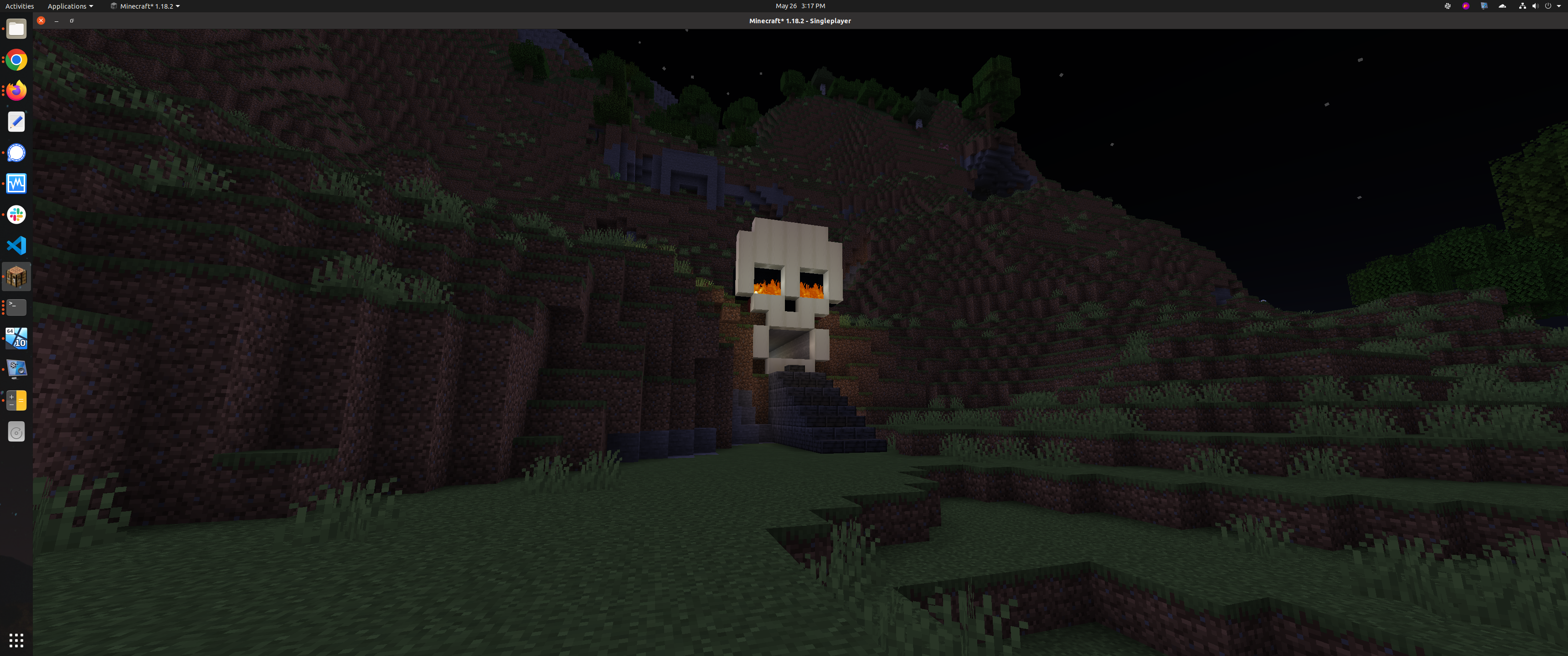 A large skull structure built into a grassy hill as an entrance to a Minecraft skeleton spawner farm