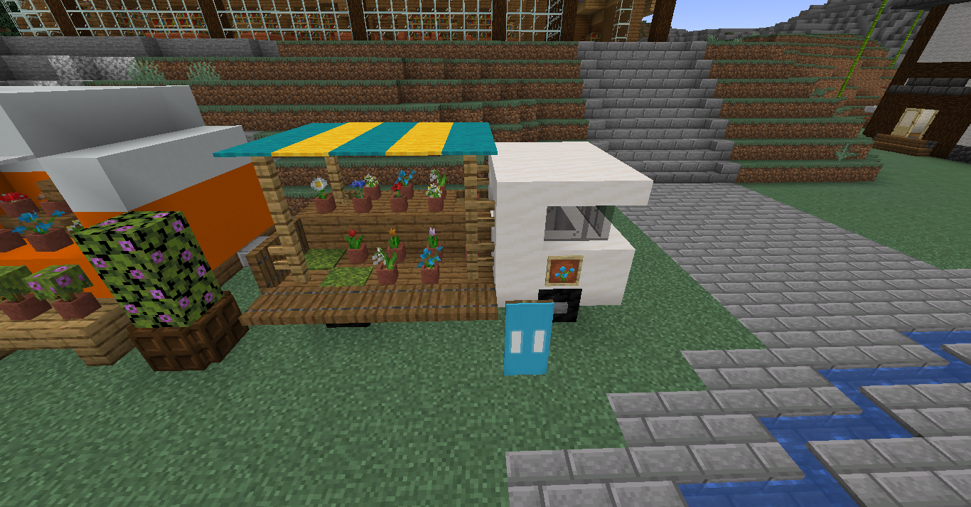 Cute small Minecraft builds of a flower shop with orange and white stalls and a FLOWERS sign