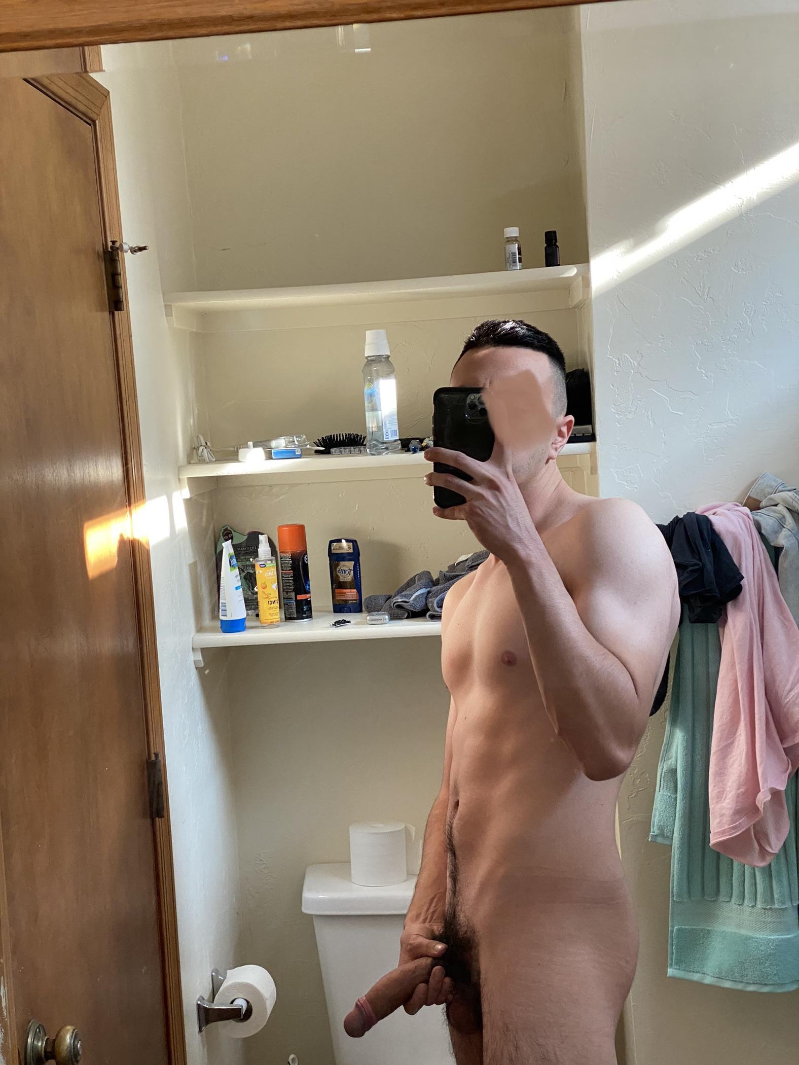Athletic white man with a huge uncut penis posing for pelfies in a bedroom and bathroom