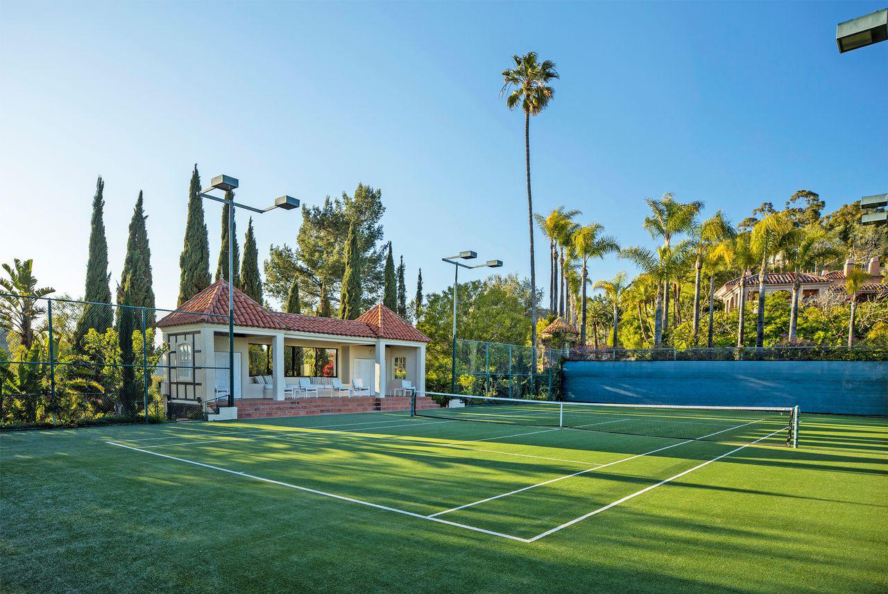 Lebron James luxury estate featuring a tennis court, swimming pool, living room, and home theater