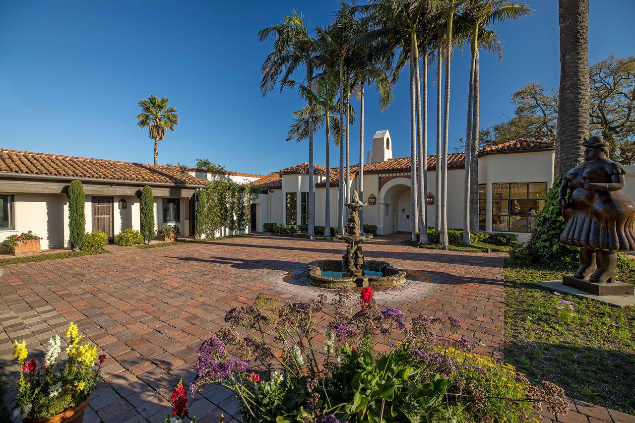 Lebron James luxury estate featuring a tennis court, swimming pool, living room, and home theater