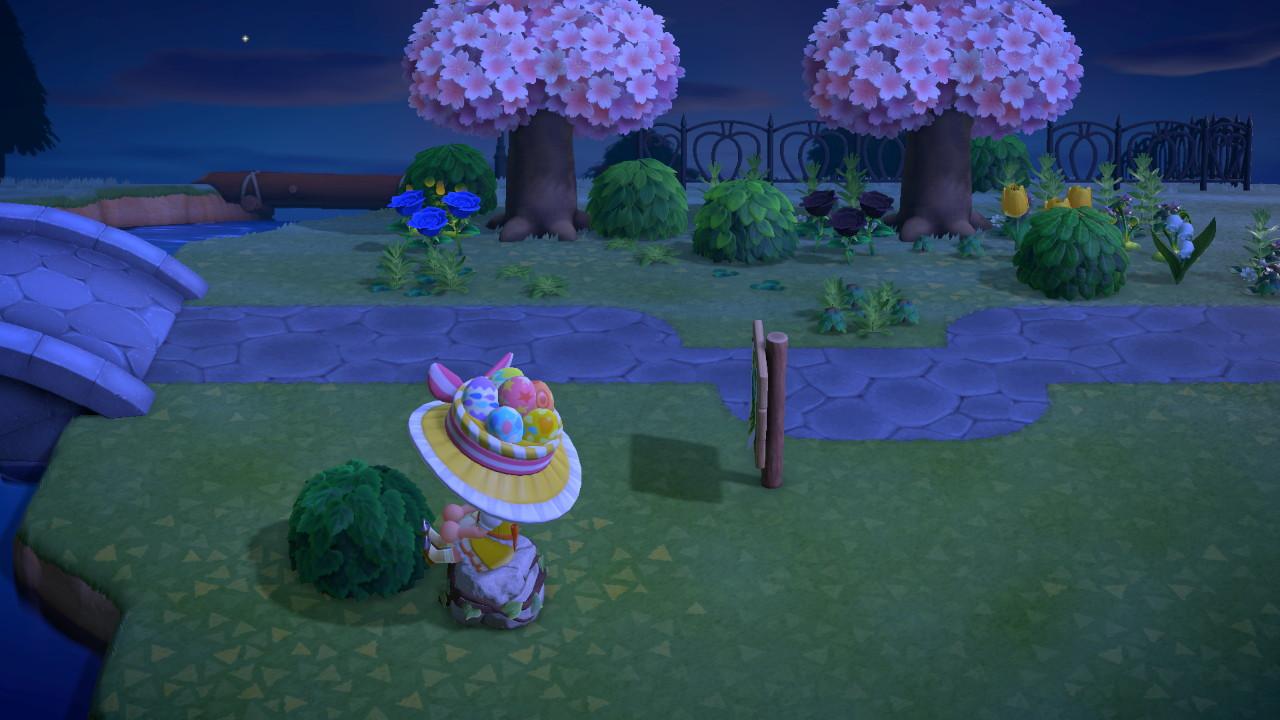 Animal Crossing: New Horizons character in a yellow floral dress and wide-brimmed hat by a bridge with cherry blossom trees