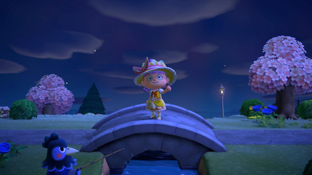 Animal Crossing: New Horizons character in a yellow floral dress and wide-brimmed hat by a bridge with cherry blossom trees