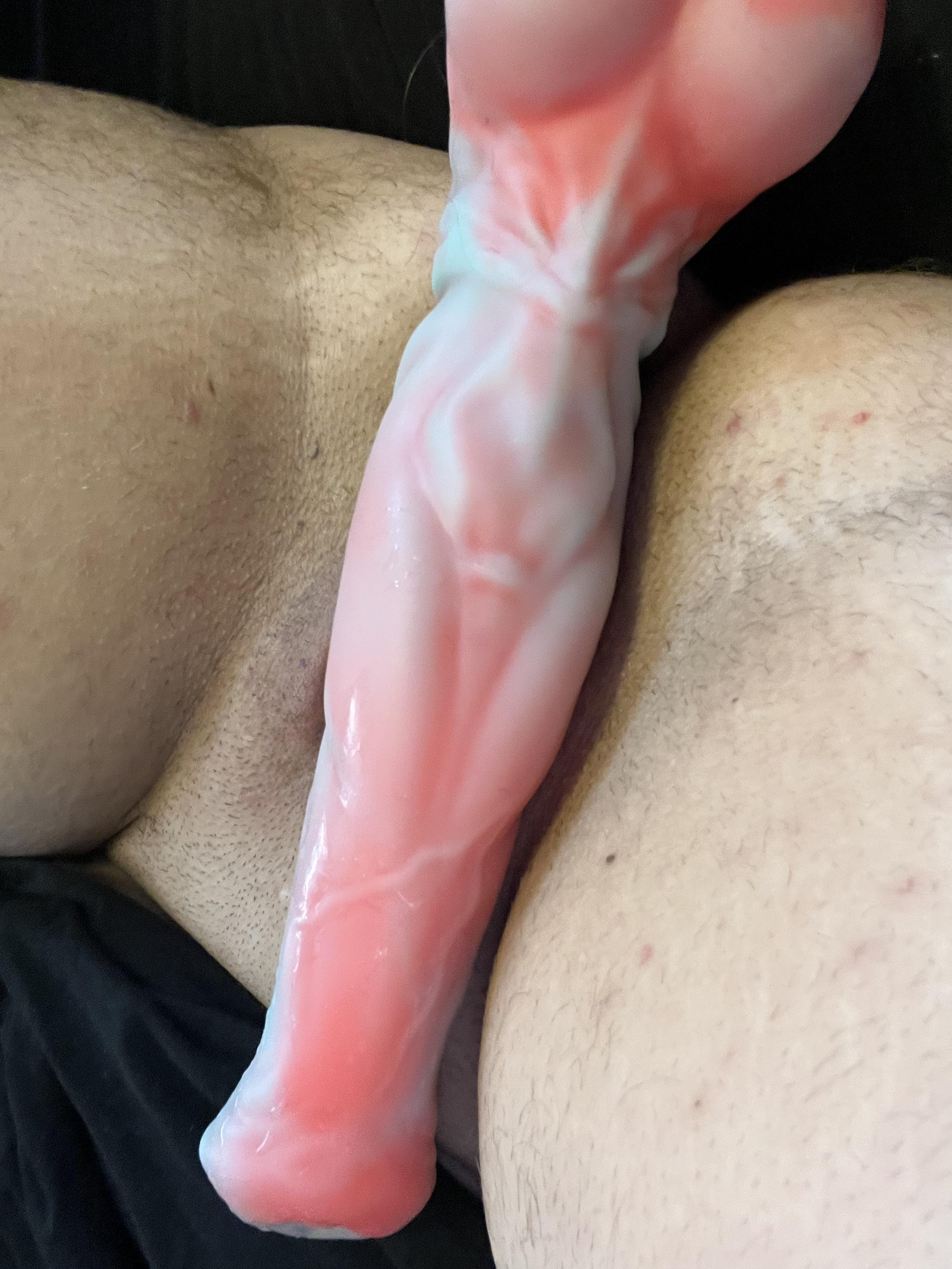 FTM cow man using a red and white anal dildo for penetration