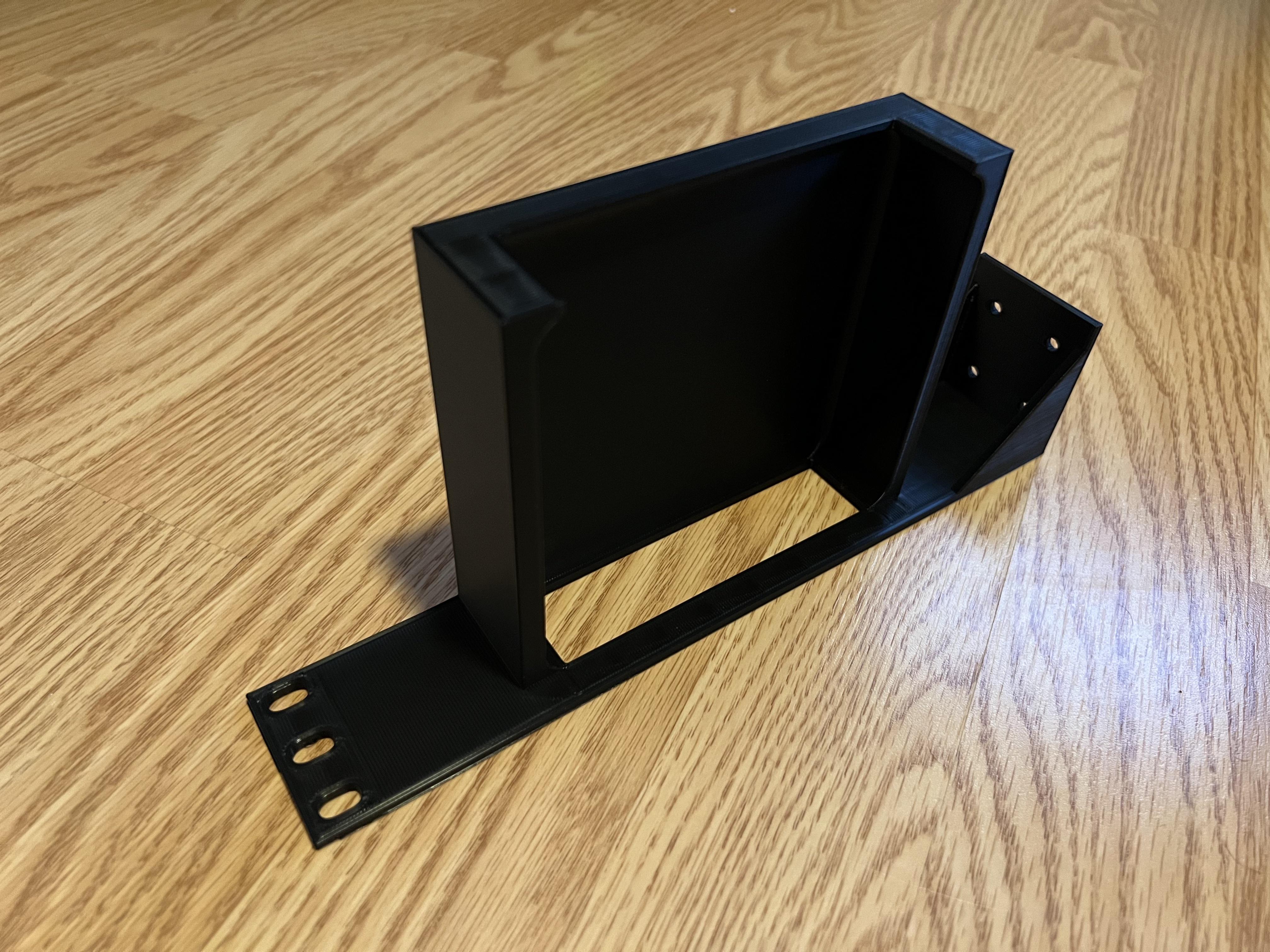 Custom modular server rack mount 3D-printed in black plastic on a wooden surface.