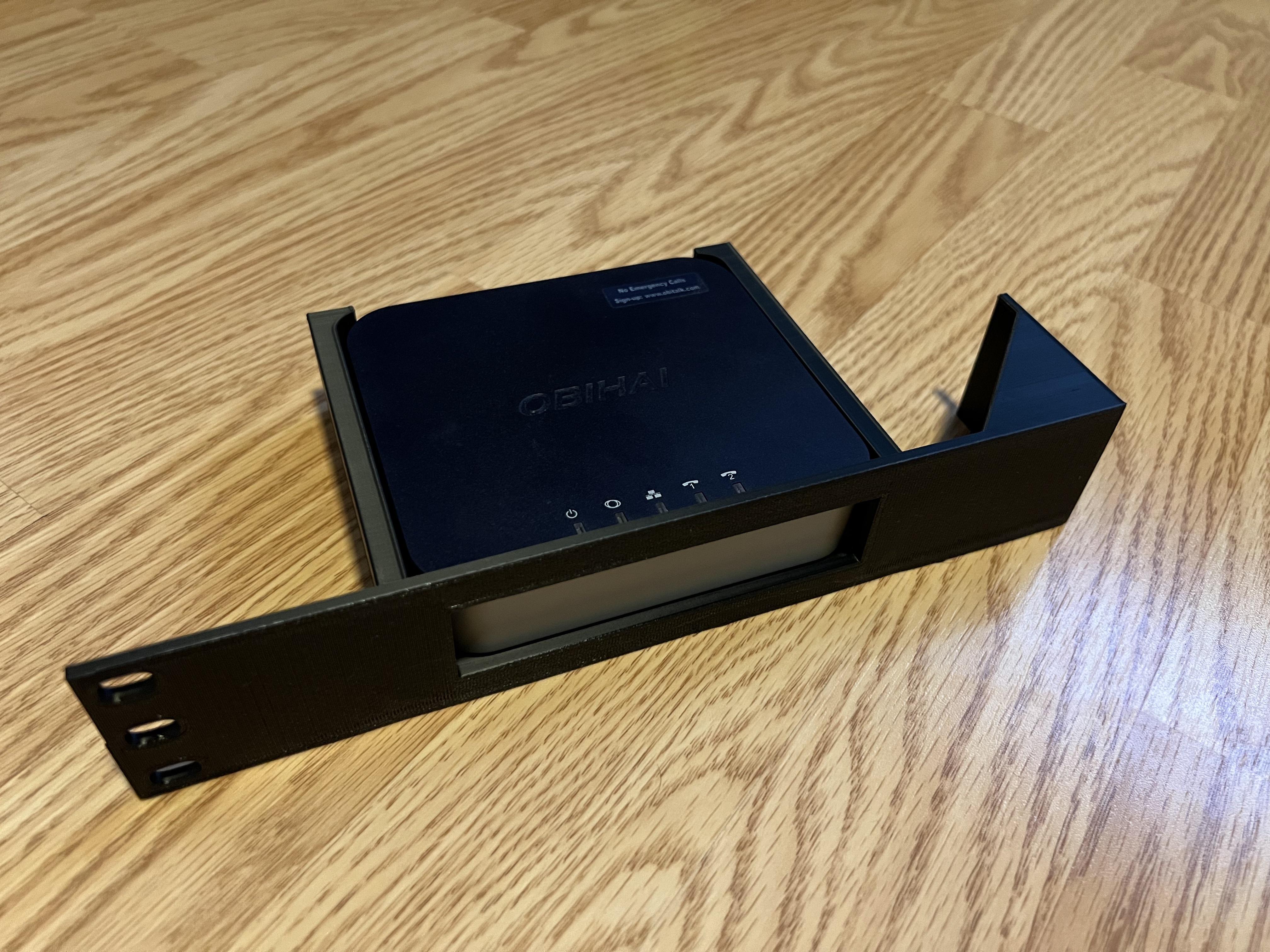 Custom modular server rack mount 3D-printed in black plastic on a wooden surface.