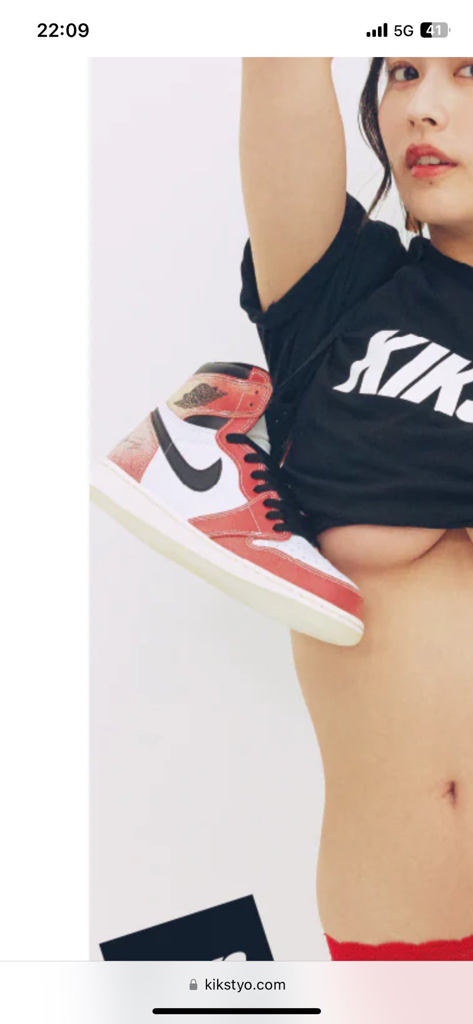 Yoshino Chitose in a cropped black t-shirt and red panties holding a sneaker