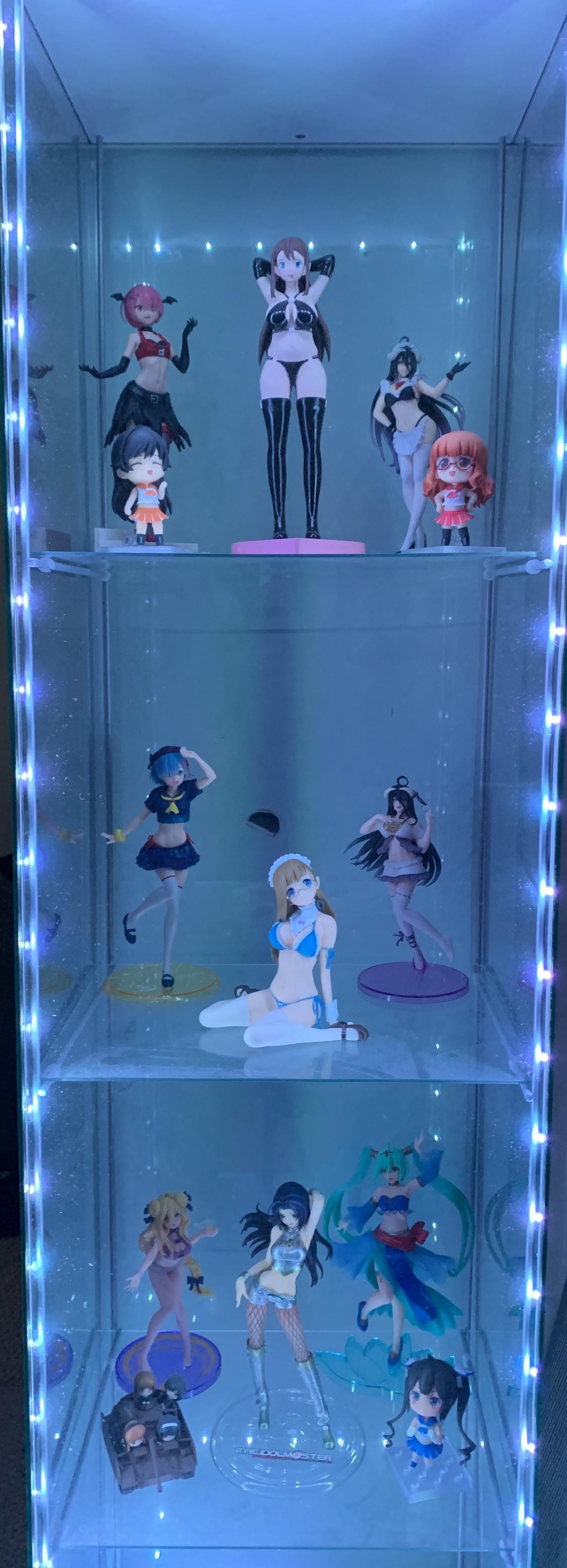 Hatsune Miku anime figures and gaming pc desk setup with LED display cases