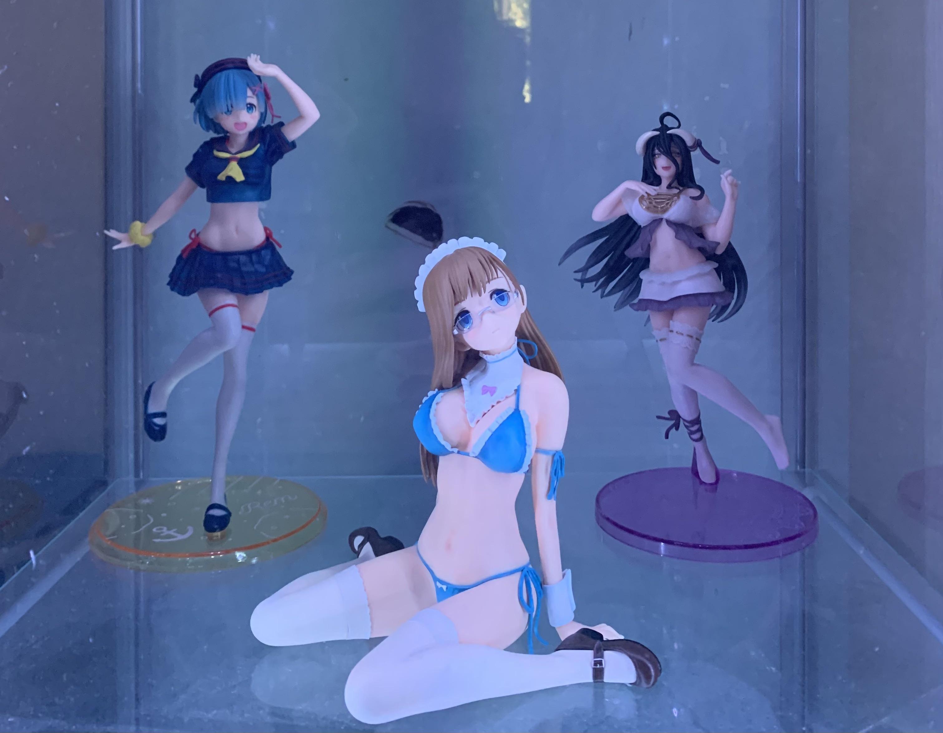 Hatsune Miku anime figures and gaming pc desk setup with LED display cases
