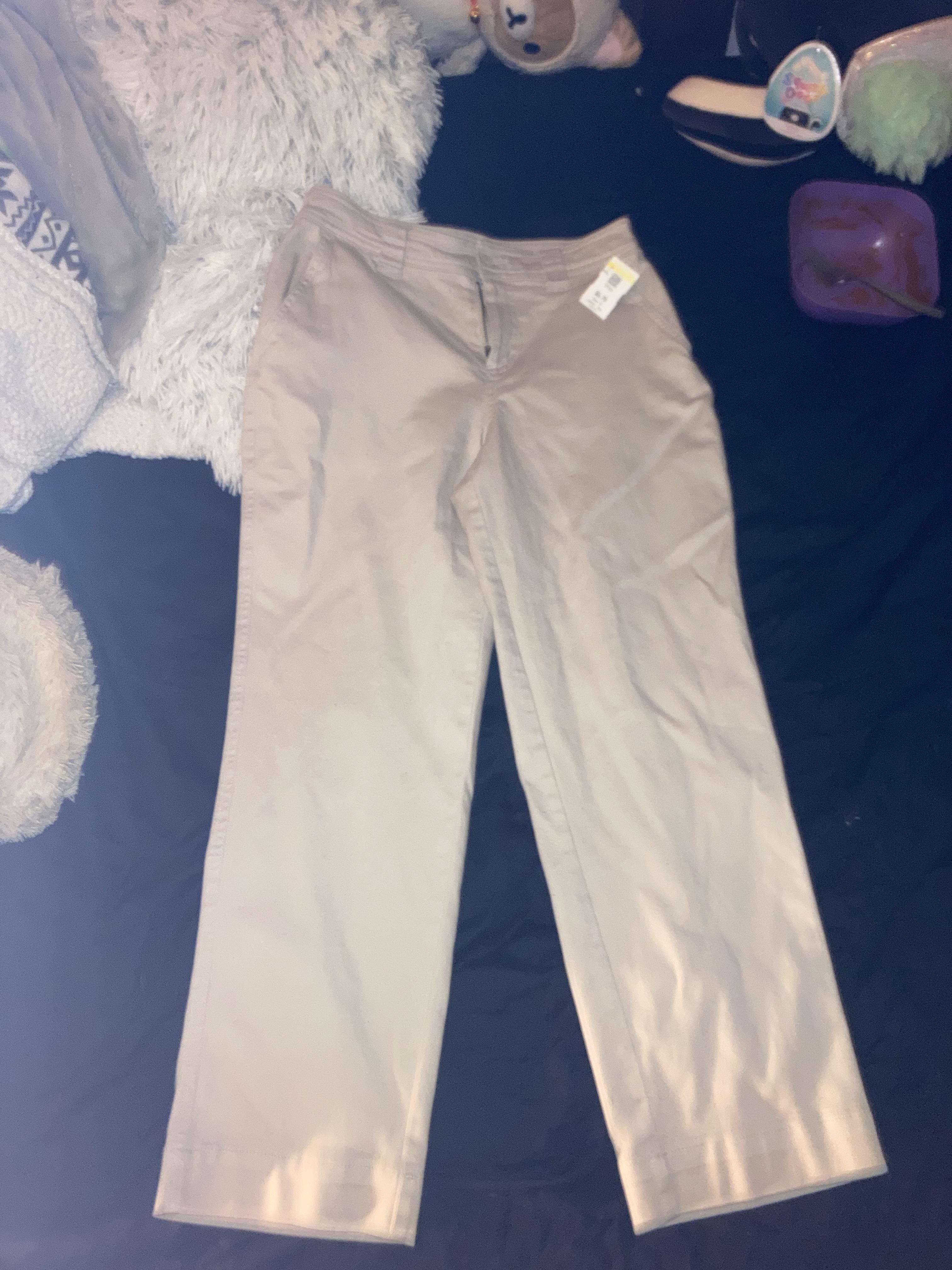 Thrift haul featuring a Hello Kitty tank top, sunflower white shirt, pink tutu top, and a striped turtleneck