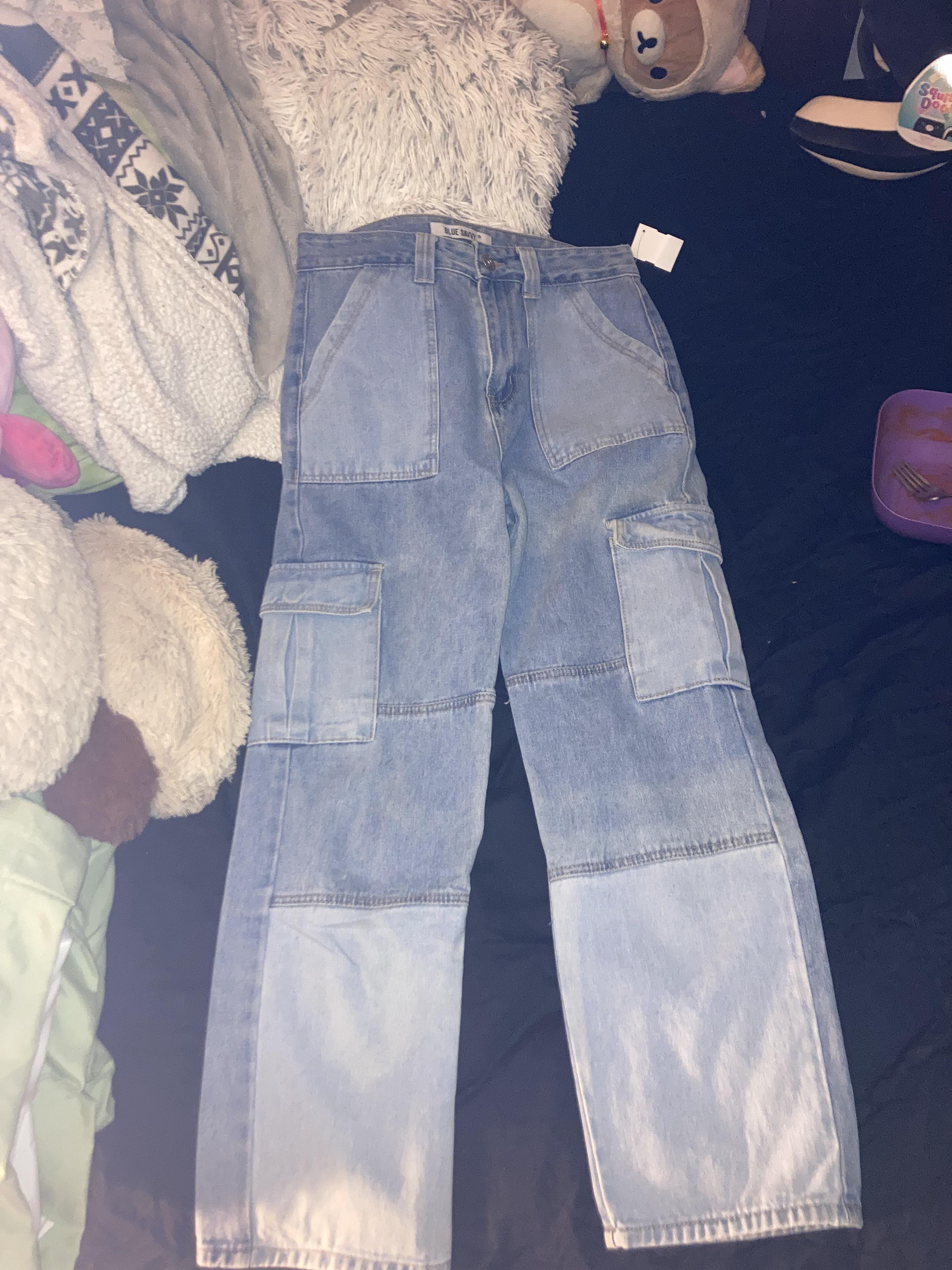 Thrift haul featuring a Hello Kitty tank top, sunflower white shirt, pink tutu top, and a striped turtleneck