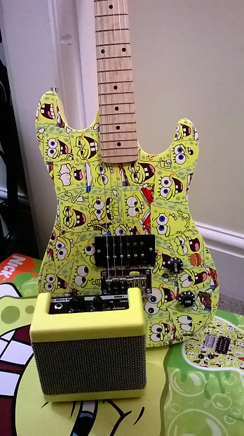SpongeBob guitar with a yellow cartoon pattern and a small amplifier