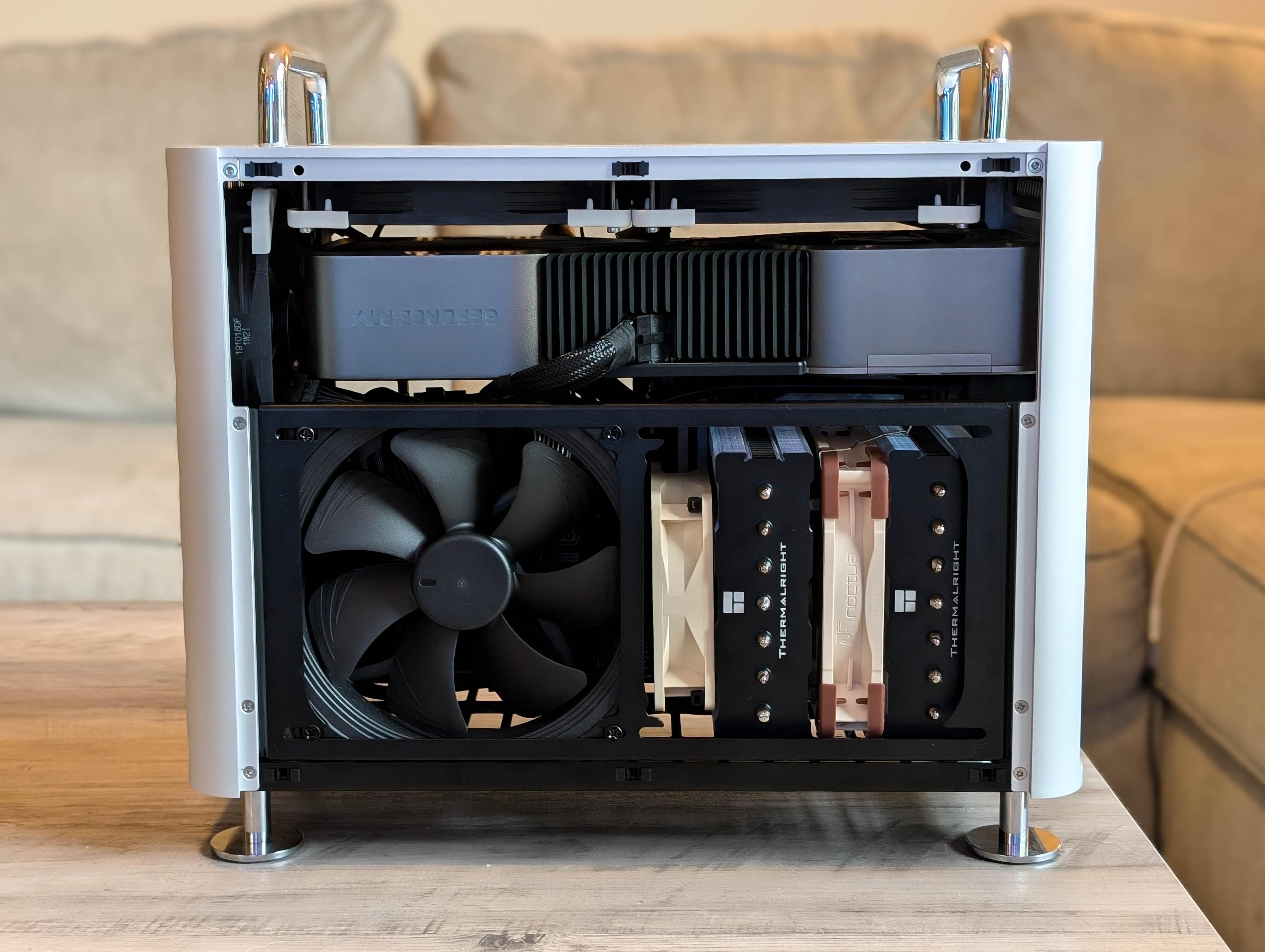 McPrue Apollo S v3 white compact custom gaming PC build on a desk with monitors, keyboard, and headphones