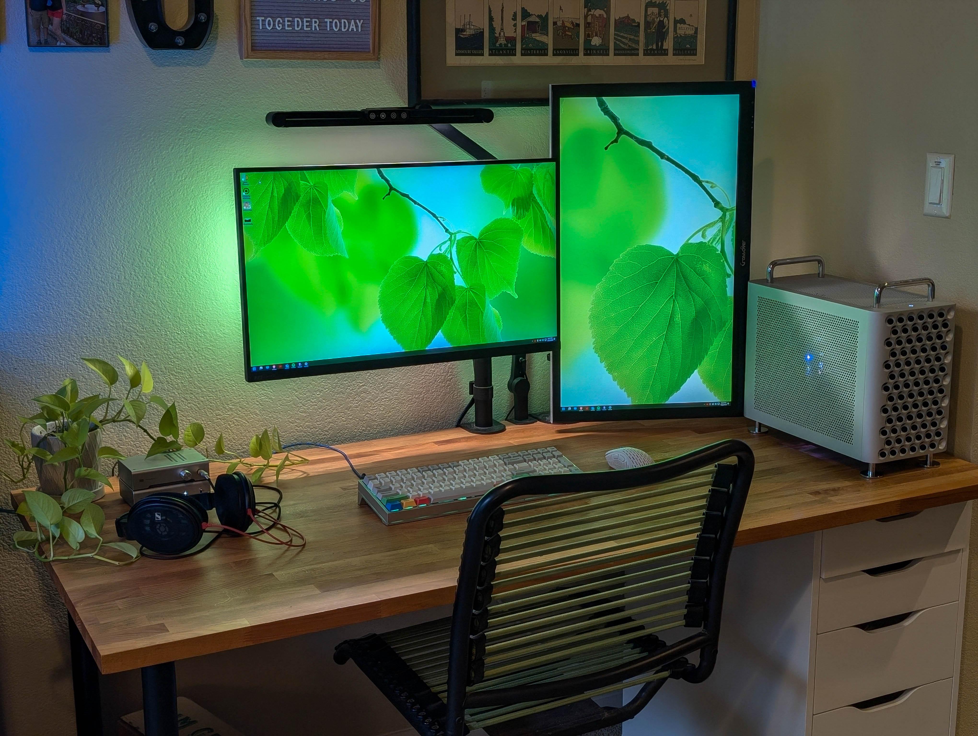 McPrue Apollo S v3 white compact custom gaming PC build on a desk with monitors, keyboard, and headphones