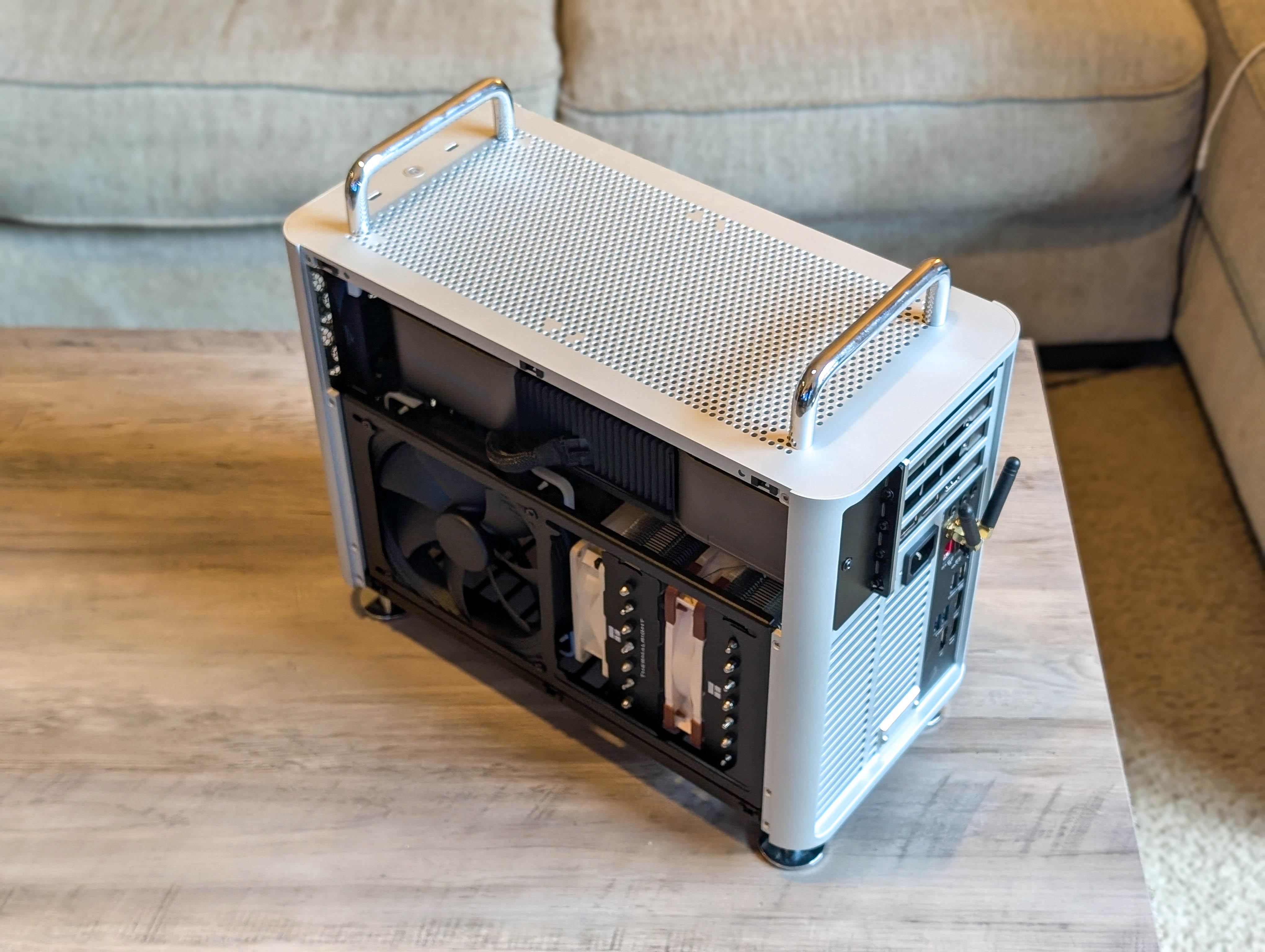 McPrue Apollo S v3 white compact custom gaming PC build on a desk with monitors, keyboard, and headphones