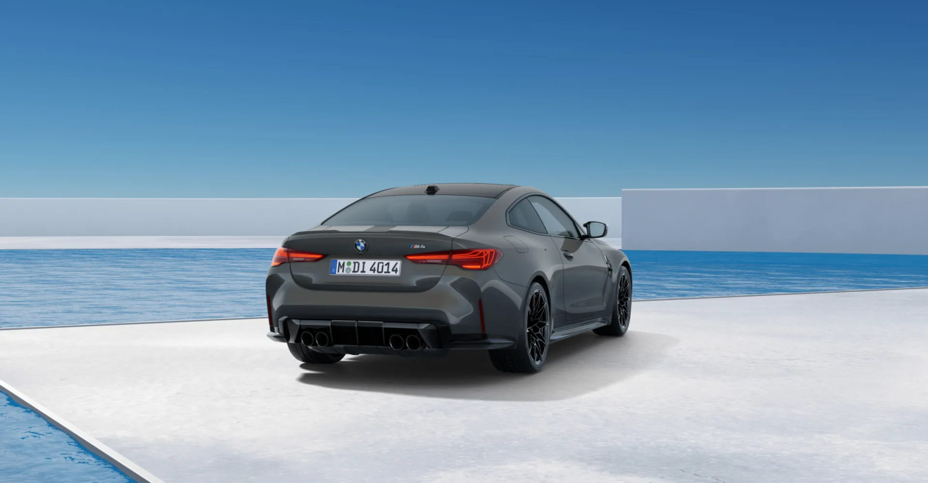 Grey BMW M8 coupe in a minimalist white architectural space by the ocean