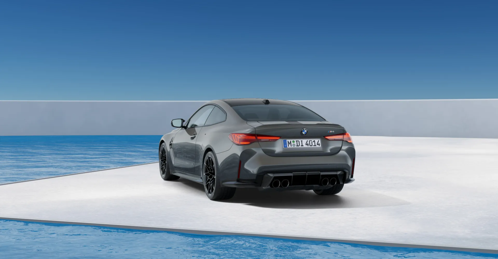 Grey BMW M8 coupe in a minimalist white architectural space by the ocean