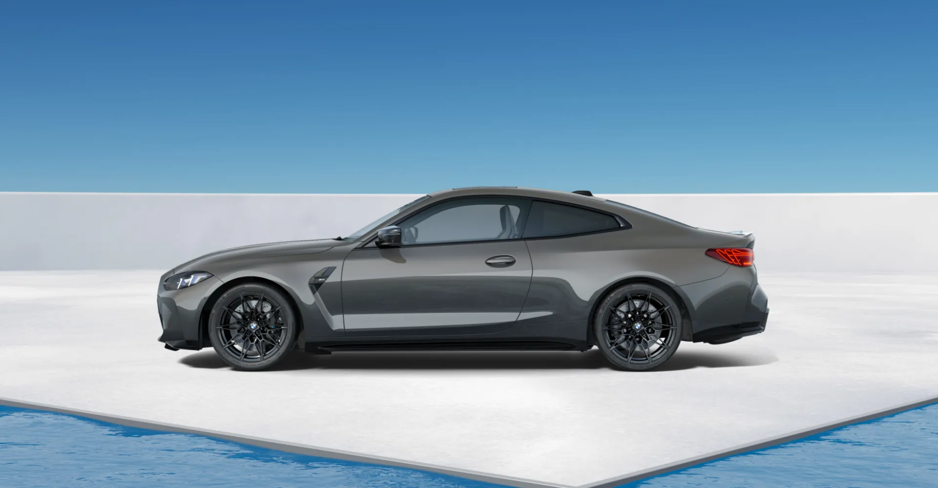 Grey BMW M8 coupe in a minimalist white architectural space by the ocean
