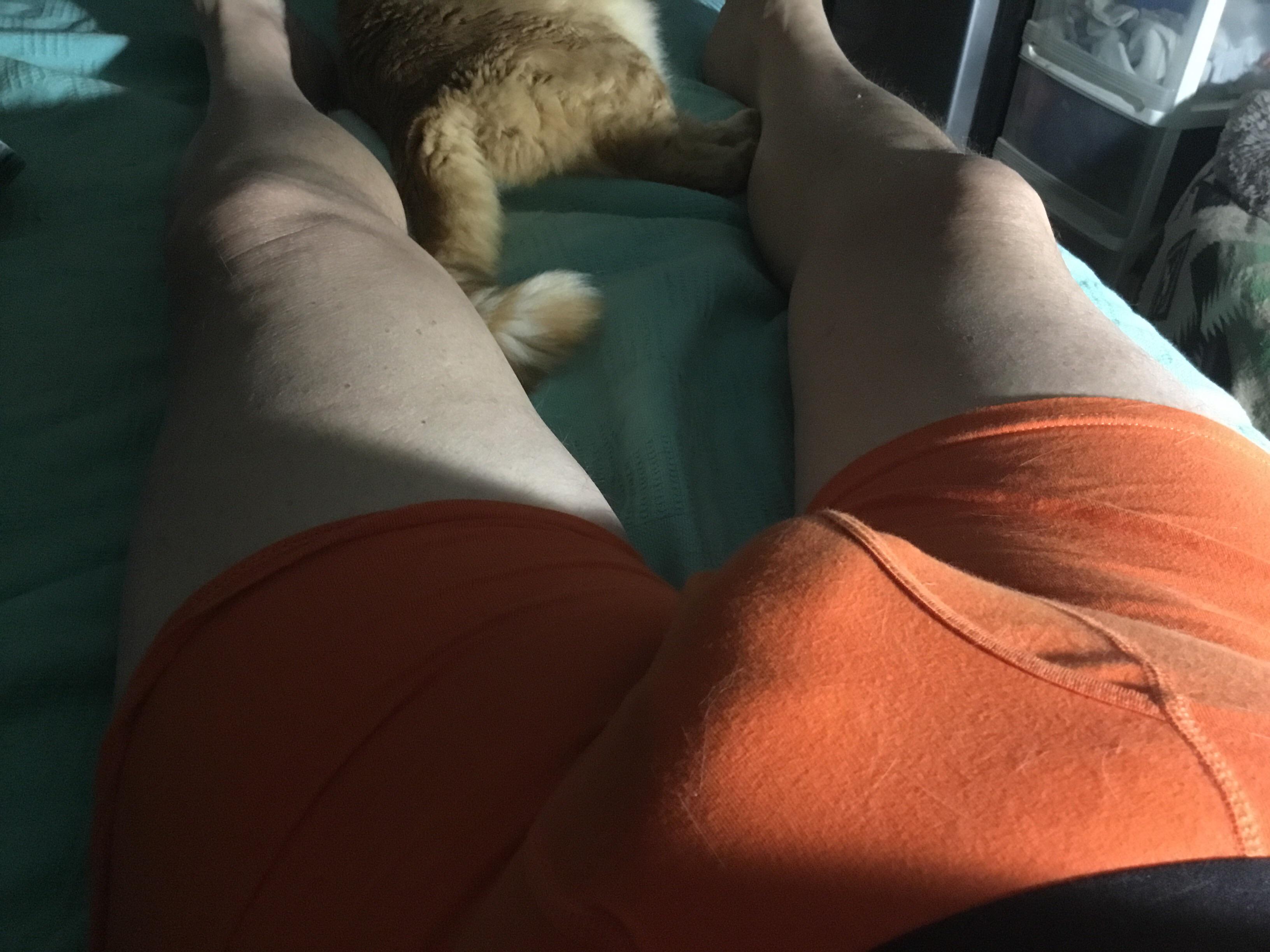 Daddy in orange shorts exposing his uncut white cock and balls in a bedroom